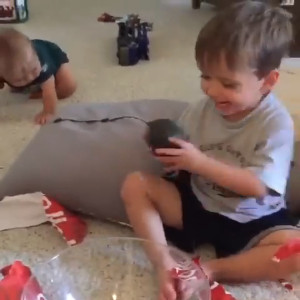 Thumbnail for Little Boy Unwraps A Present that links to Watch Video page.